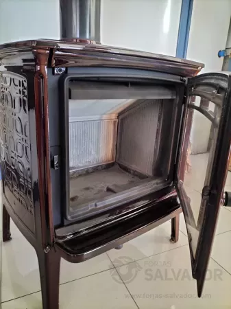 Primer plano de la puerta de hierro fundido y cristal cerámico de la estufa Hergom Shelburne HF, destacando su diseño duradero.